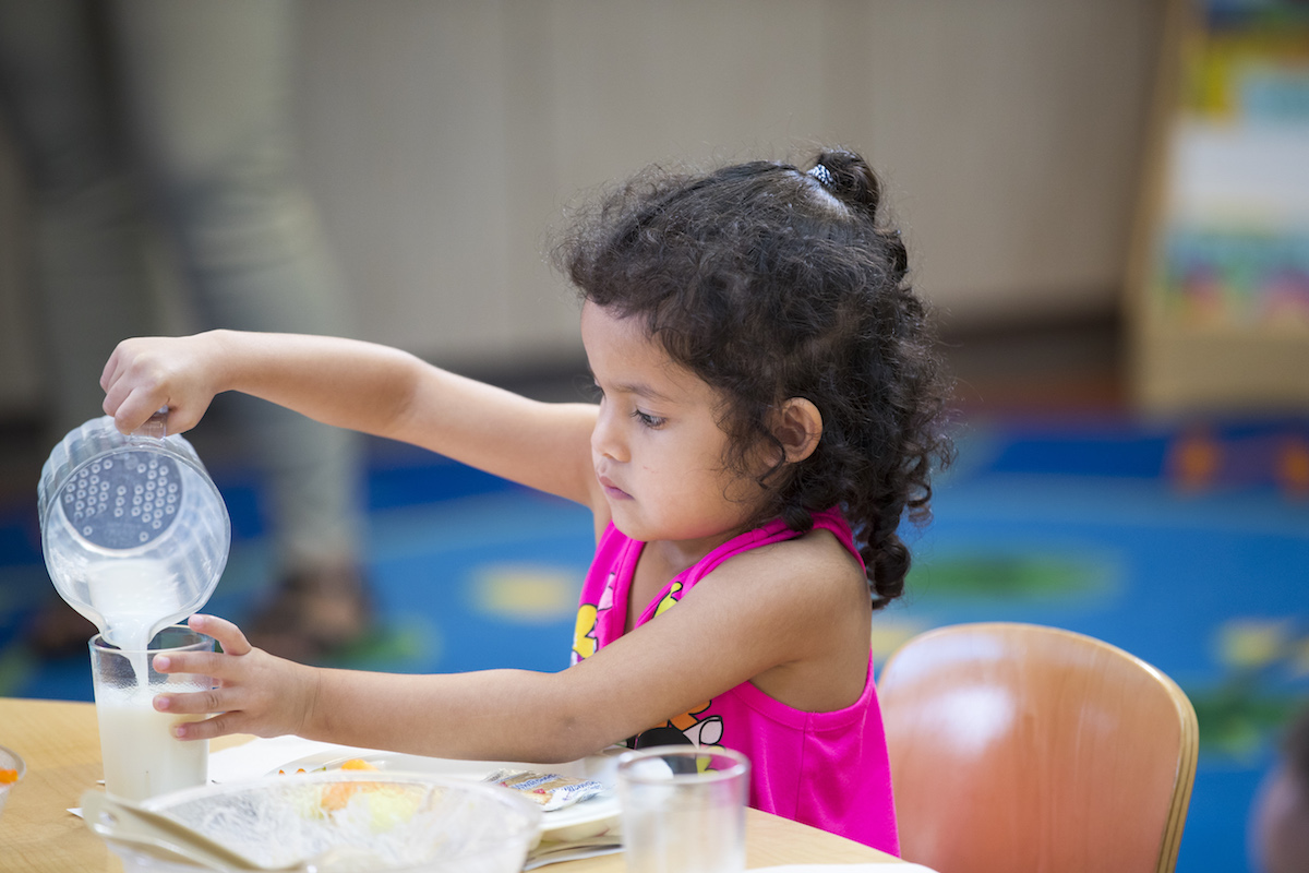 girl pouring milk